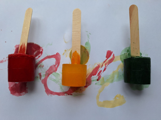 Coloured ice with lolly stick handles for painting with.