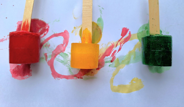 Coloured ice with lolly stick handles for painting with.