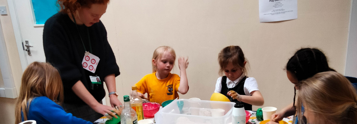 Group of children and adult doing a science and craft activity