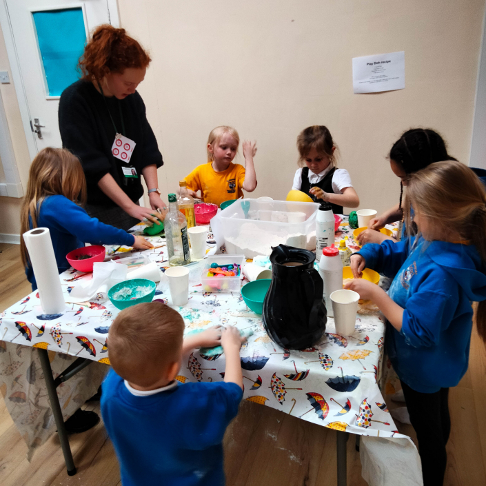 Group of children and adult doing a science and craft activity